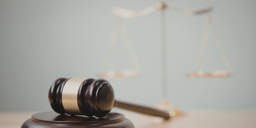 Gavel and scales of justice on a wooden surface