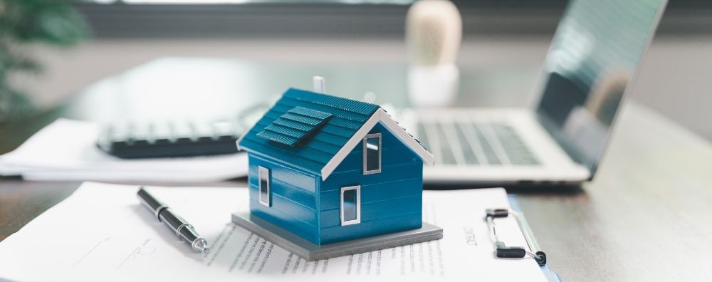 House model placed on table alongside coins, paperwork symbolizes real estate investment, property valuation, representing financial planning, mortgage options, market analysis in property busines House model placed on table alongside coins, paperwork symbolizes real estate investment, property valuation, representing financial planning, mortgage options, market analysis in property business.